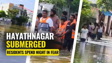 GHMC officials and residents wading through the flooded streets of Banjara Colony in Hayathnagar after heavy rainfall on Sunday night.